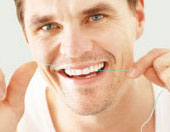 man flossing teeth